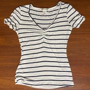 Size small. White and black striped blouse with v neck and a cinched front